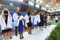 Members of the VP&S Class of 2025 are cloaked in white coats. Photo credit: Eileen Barroso